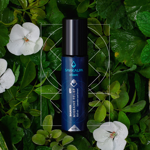 Shunyata migraine relief roll on product image with a backgrop of green leaves and white periwinkle