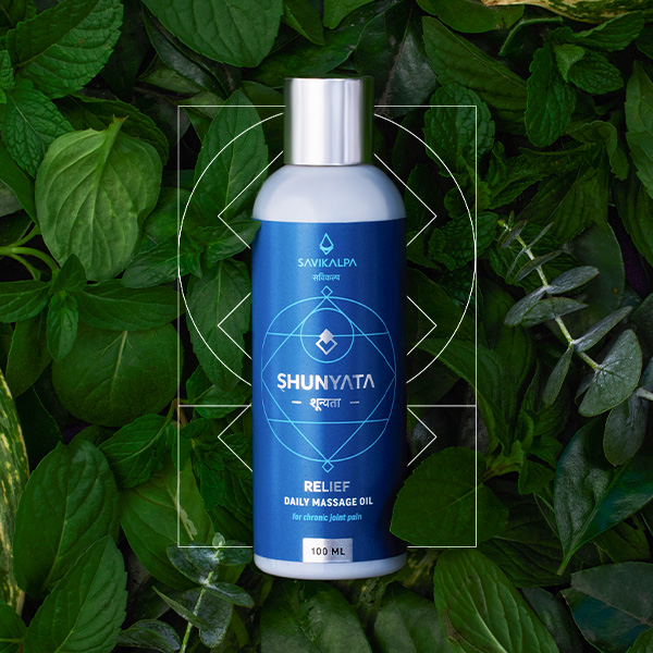 Shunyata pain relief oil product image with a backgrop of green leaves