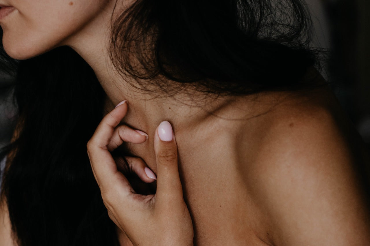 Image of woman touching her neck