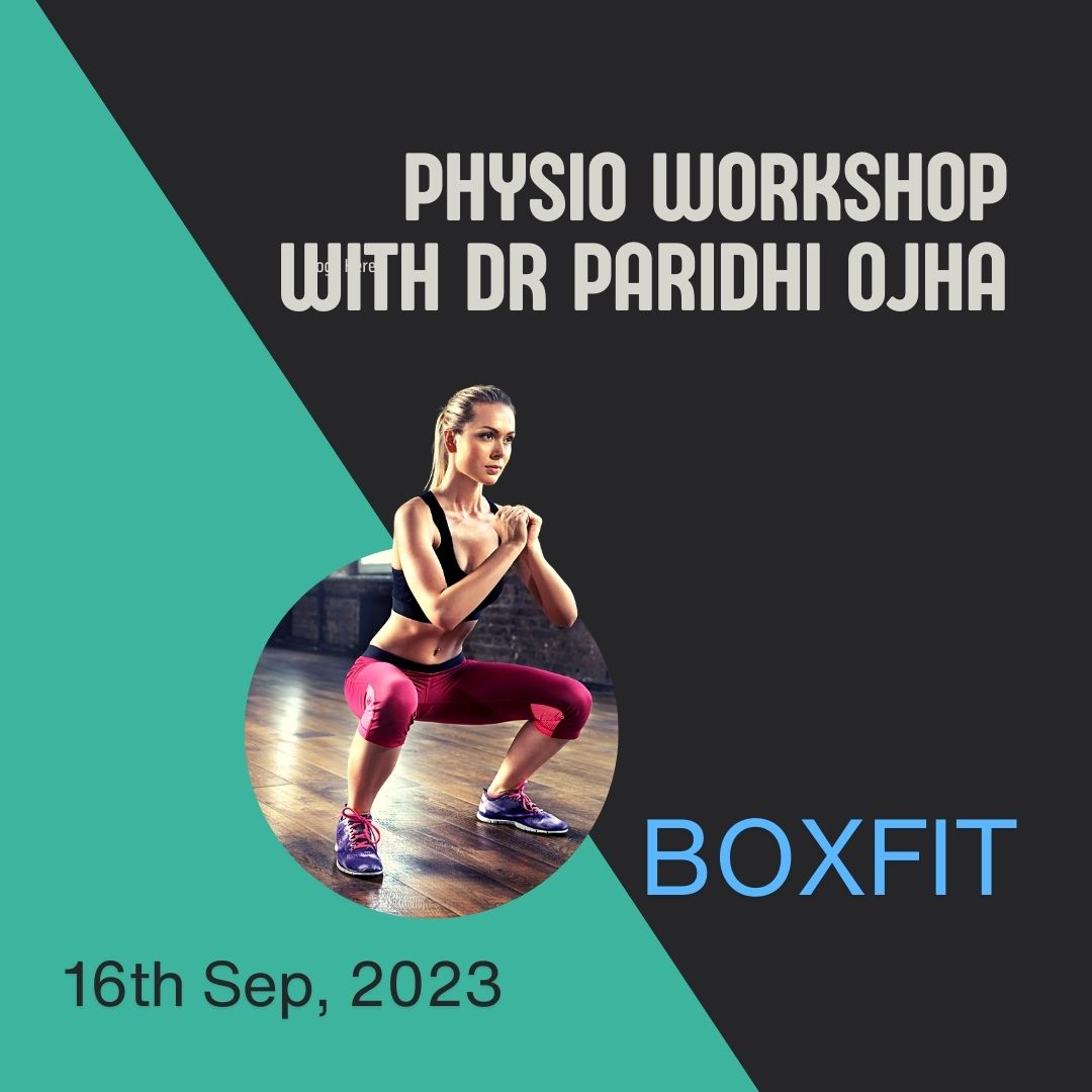 Group of people engaging in a discussion inside a gym, surrounded by fitness equipment at BoxFit by Ajay