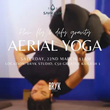 Woman performing aerial yoga