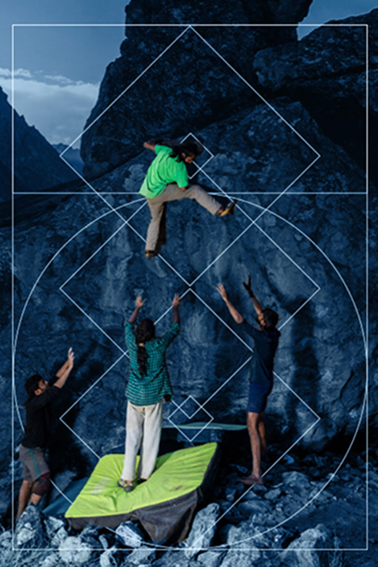People climbing with a backdrop of mountains and savikalpa brand map - Portrait Image