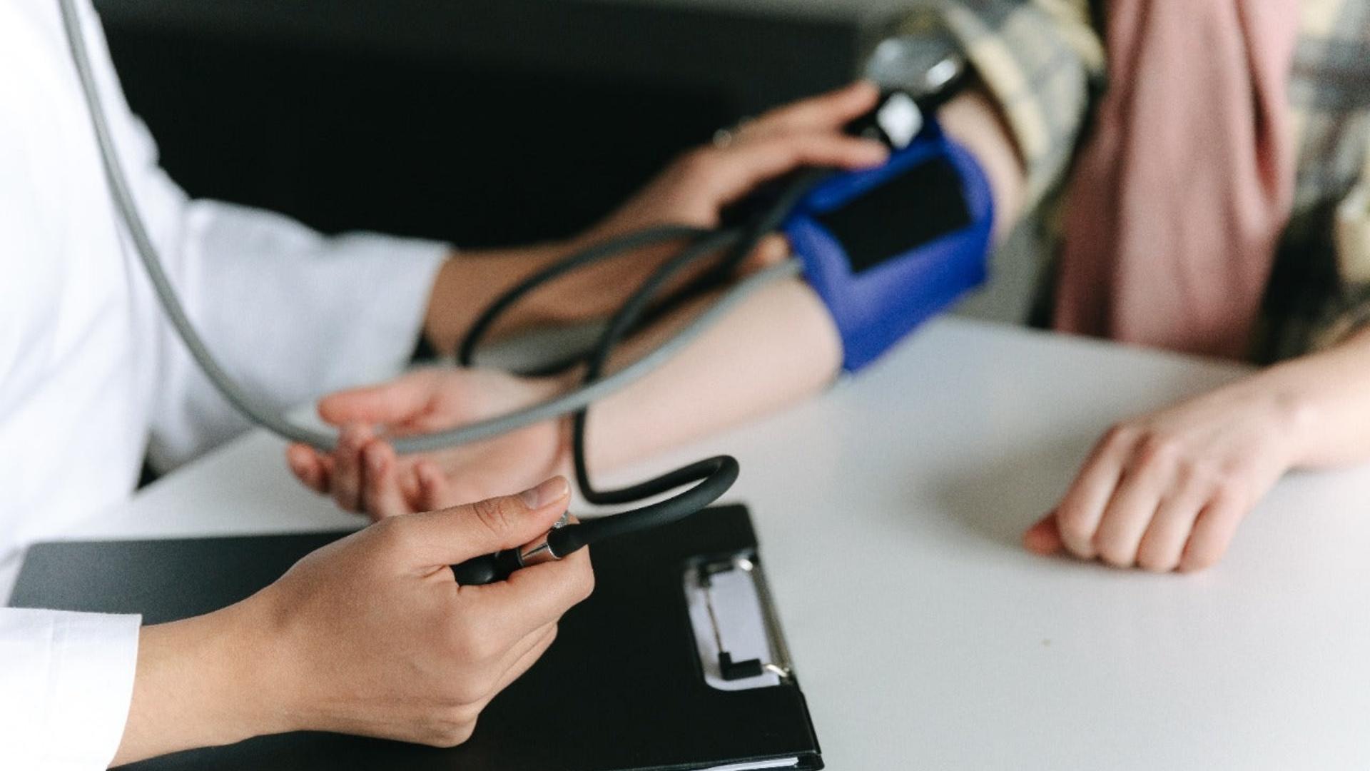 A doctor assesses a patient's blood pressure, focusing on how medical cannabis influences hypertension levels