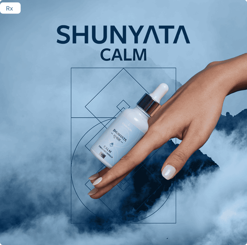 A hand holding a Shunyata Calm dropper bottle against a misty blue mountain scene.