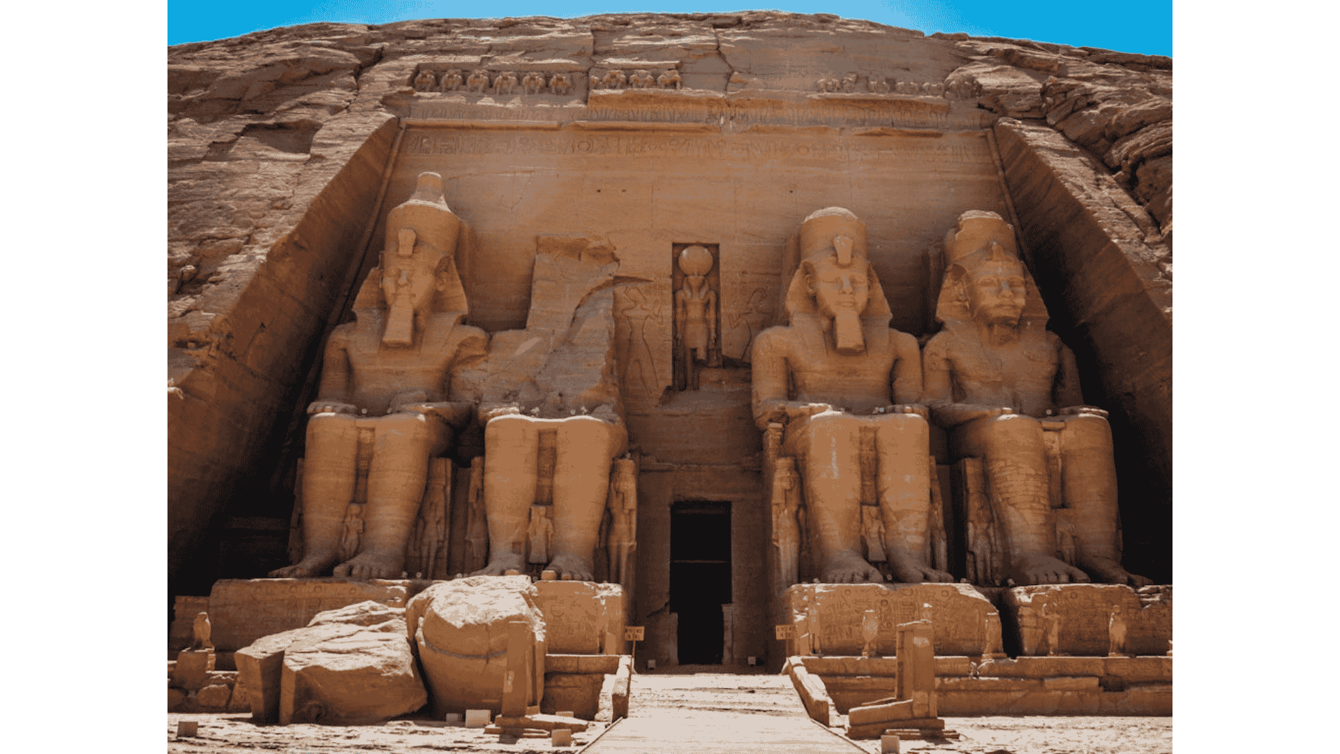The Abu Simbel Temple's grand entrance in Egypt showcasing colossal statues and ancient Egyptian script