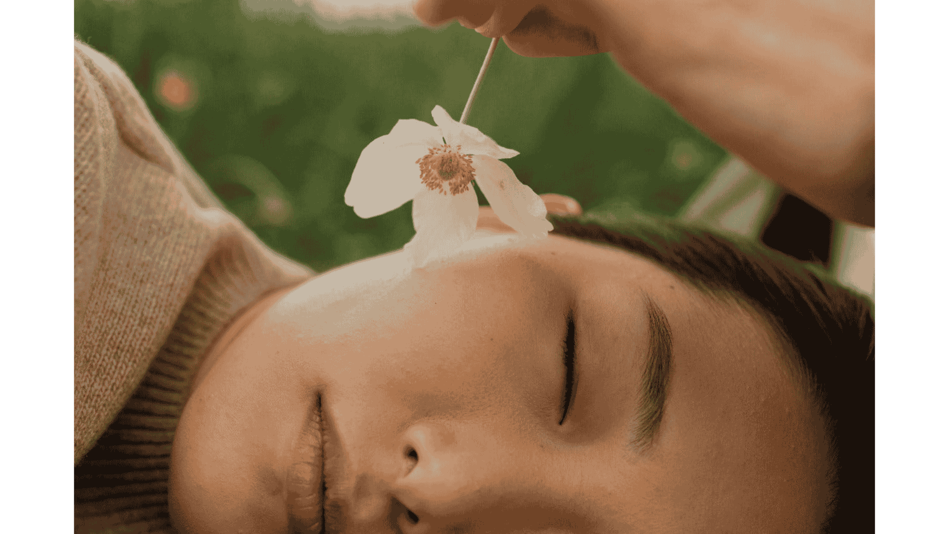 A woman lying in the grass symbolising the benefits of cannabis medication for improved sleep and relaxation