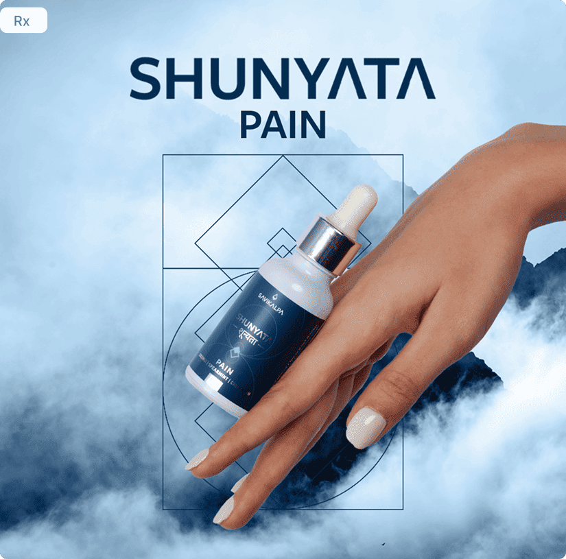 A hand holding a Shunyata Pain dropper bottle over a misty blue mountain background.