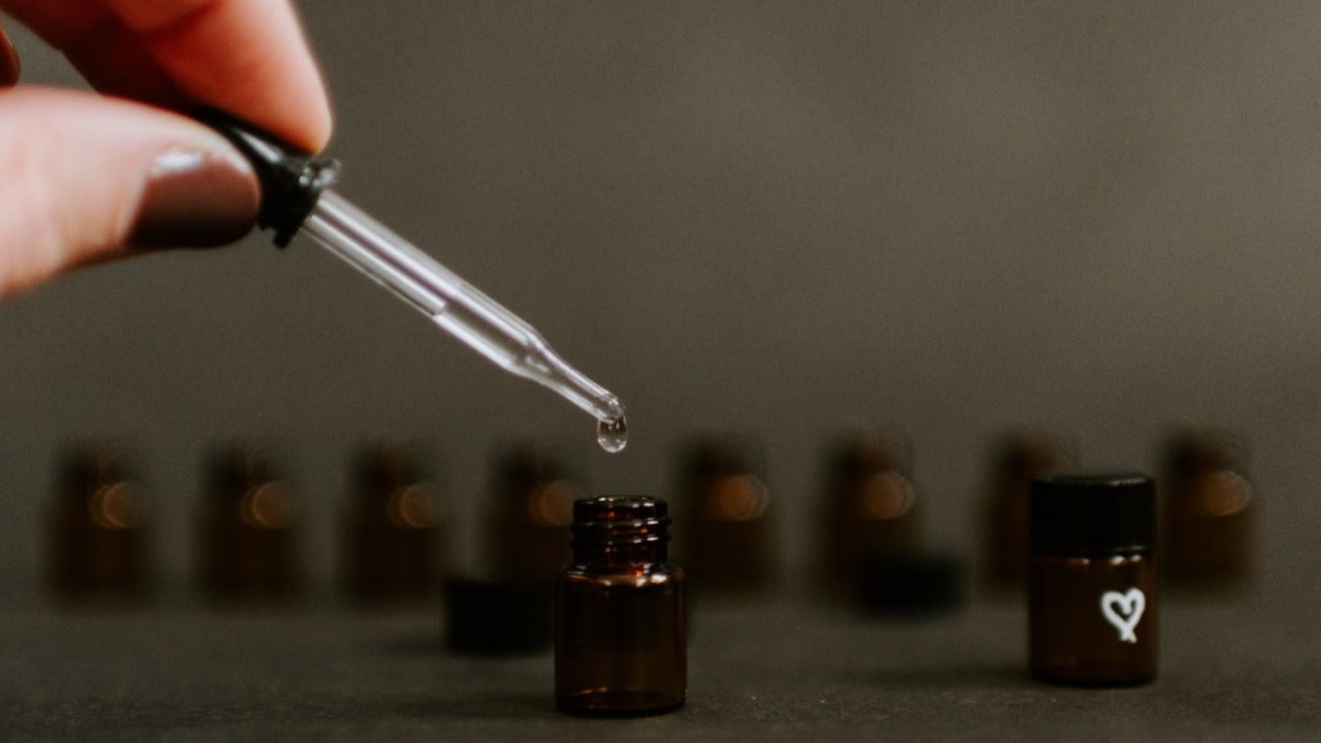 An individual is transferring cannabis oil, demonstrating titration techniques for cannabis medicine dosages